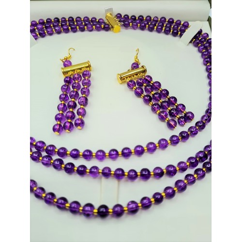 50 - A three row amethyst necklace and matching earrings set in a presentation box. Necklace length: 47 -... 