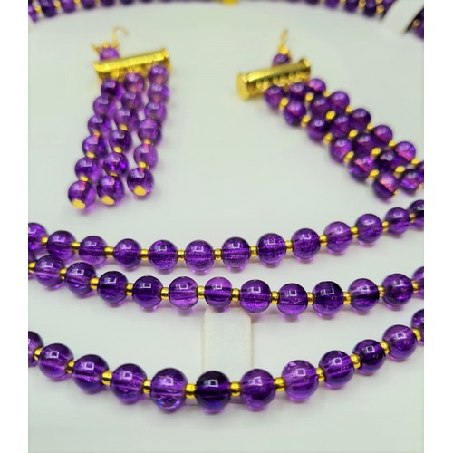 50 - A three row amethyst necklace and matching earrings set in a presentation box. Necklace length: 47 -... 