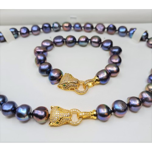 22 - A Polynesian black pearl necklace and bracelet set with Cartier style yellow metal (untested) and cl... 