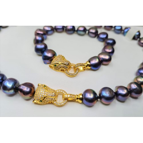 22 - A Polynesian black pearl necklace and bracelet set with Cartier style yellow metal (untested) and cl... 