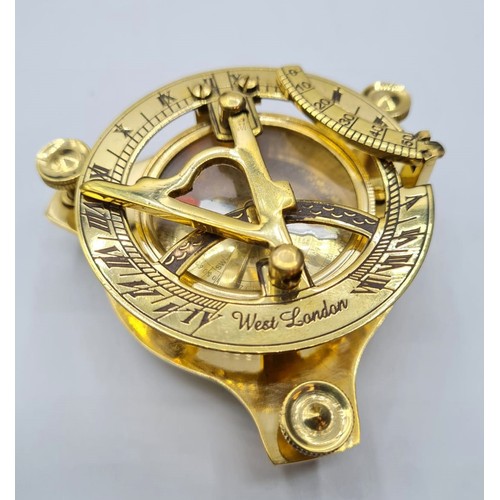 61 - A British miniature marine sundial with compass and adjustable feet in excellent working order in a ... 