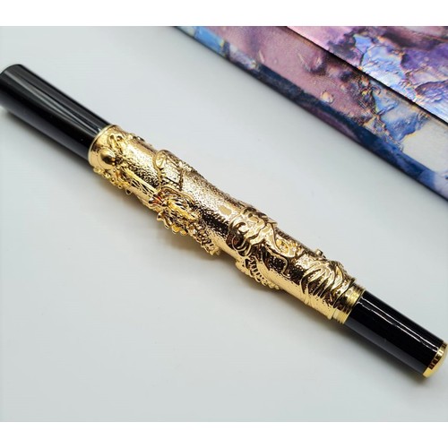 53 - A Chinese writing black pen with an 18ct gold filled Chinese dragon with red Gem eyes. Length 13cm, ... 