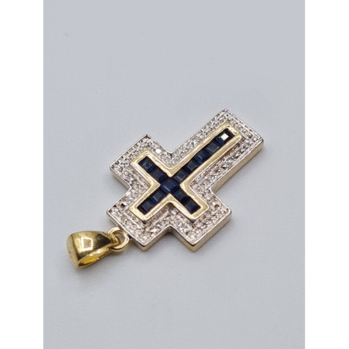 56 - 9CT YELLOW GOLD DIAMOND & SAPPHIRE CROSS, WEIGHT 2.8G