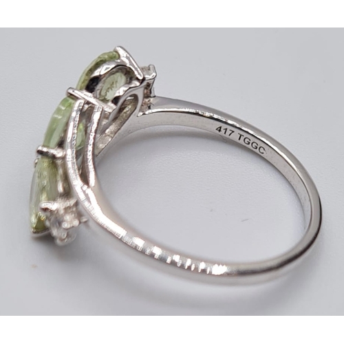 129 - 9ct White Gold Twist Ring Having a Trilogy of Pale Green Chrysoberyl Stones, Full UK Hallmark, Size ... 