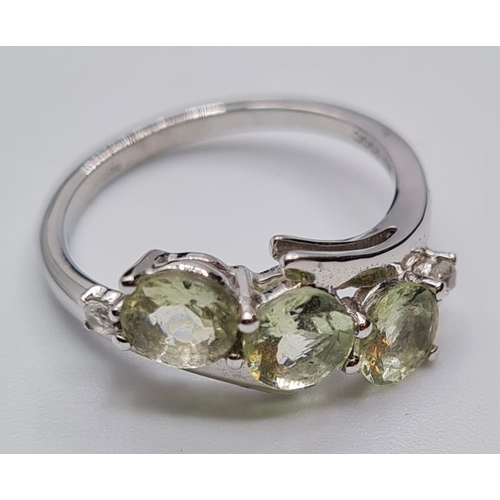 129 - 9ct White Gold Twist Ring Having a Trilogy of Pale Green Chrysoberyl Stones, Full UK Hallmark, Size ... 