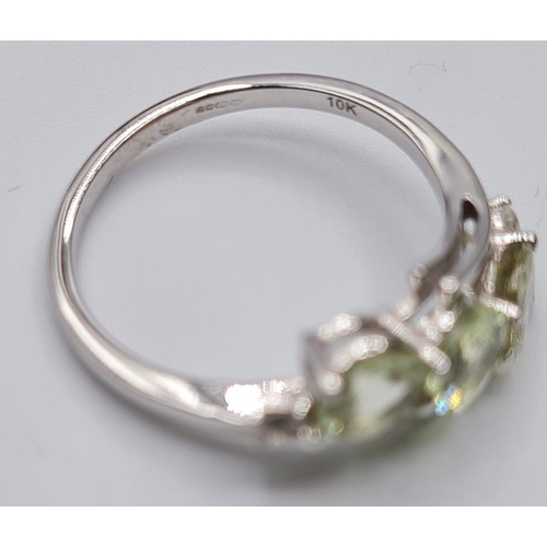 129 - 9ct White Gold Twist Ring Having a Trilogy of Pale Green Chrysoberyl Stones, Full UK Hallmark, Size ... 