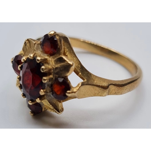 139 - 9ct Gold Ring with Five Garnets in a Flower Head Formation. Size O/P, 3.6 grams approx.