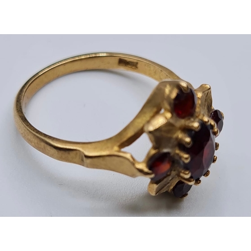 139 - 9ct Gold Ring with Five Garnets in a Flower Head Formation. Size O/P, 3.6 grams approx.