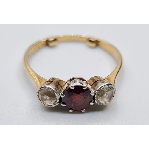 172 - 9ct gold three stone ring having a centre garnet with a white stone either side. Garnet mounted in p... 