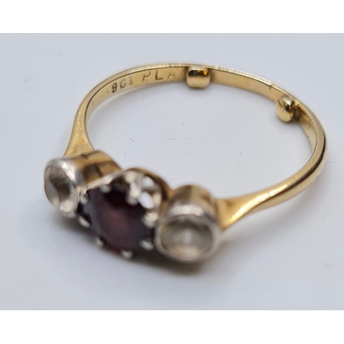 172 - 9ct gold three stone ring having a centre garnet with a white stone either side. Garnet mounted in p... 