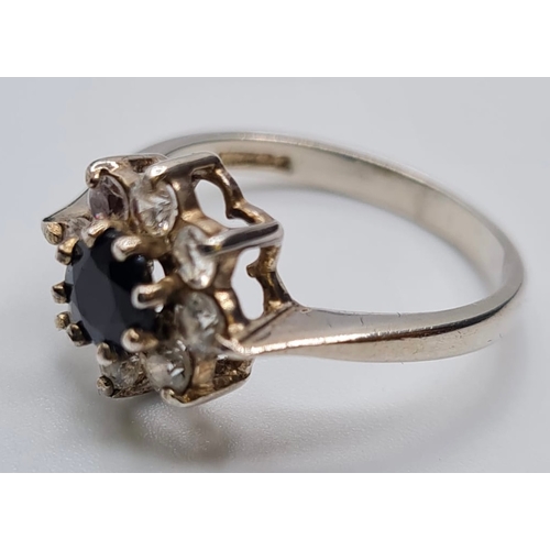 422 - Stone Set Silver Ring Having Centre Sapphire Type Stone with an Eight Point Zirconia cluster Surroun... 