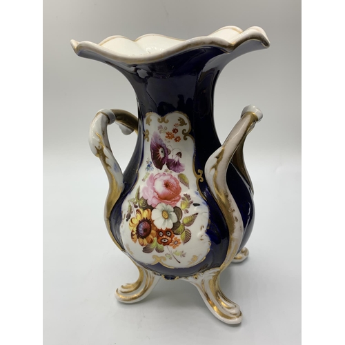 444 - A pair of Daniel four footed vases with floral cartouche, 19cms tall