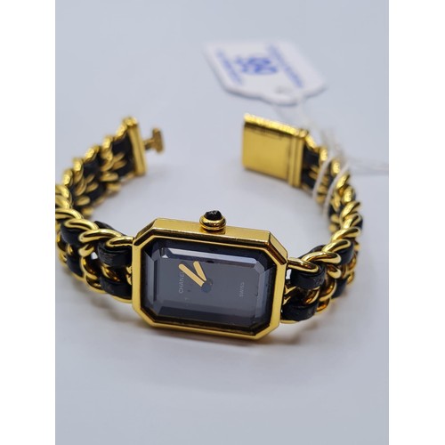 99 - Ladies Chanel dress watch with black face and leather intertwined on strap. Circa 1987