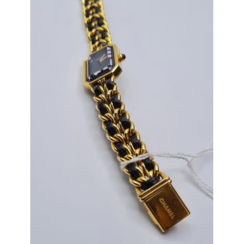 99 - Ladies Chanel dress watch with black face and leather intertwined on strap. Circa 1987