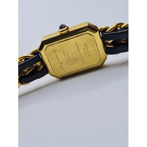 99 - Ladies Chanel dress watch with black face and leather intertwined on strap. Circa 1987