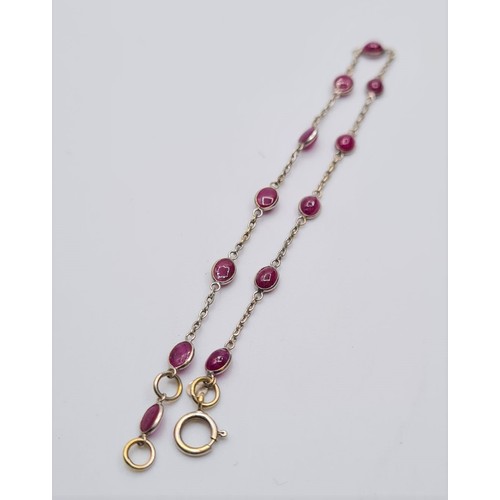 42 - 18ct gold bracelet with cabochon ruby's. Weight 1.9g and length 18cms