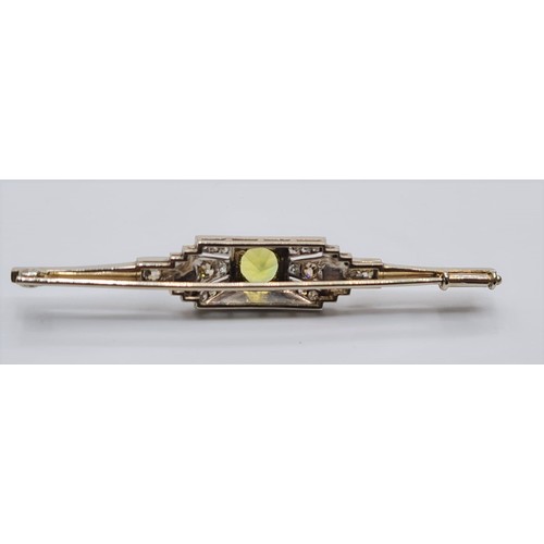 19 - An antique art deco platinum bar brooch with diamonds and central peridot 4.8  grams and length 55cm... 