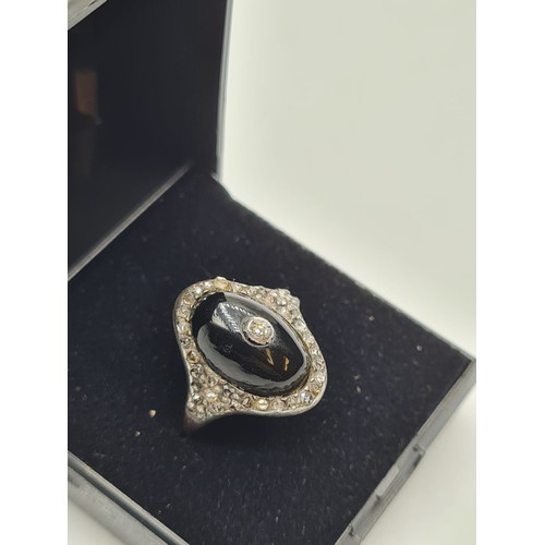 10 - Antique diamond encrusted black enamel ring with small centre diamonds,5 grams & size M.