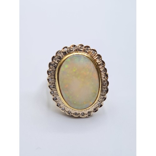 41 - 18ct gold opal and diamond ring. weight 10.3g & size M