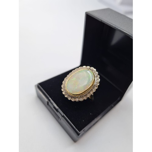 41 - 18ct gold opal and diamond ring. weight 10.3g & size M