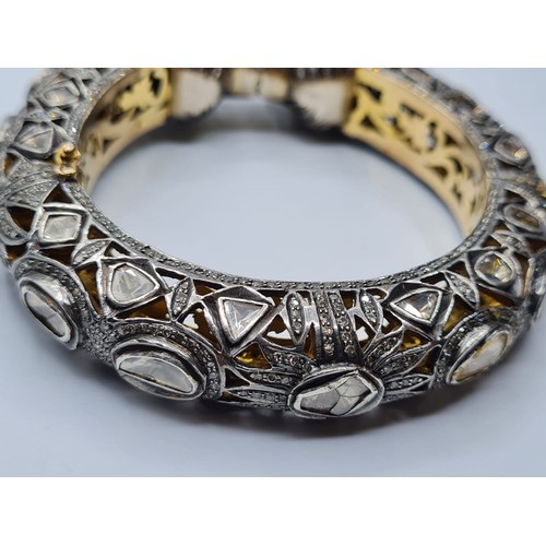 24 - An antique Cartier style yellow and white gold tigers head bangle encrusted with diamonds and comple... 