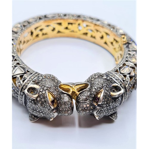 24 - An antique Cartier style yellow and white gold tigers head bangle encrusted with diamonds and comple... 