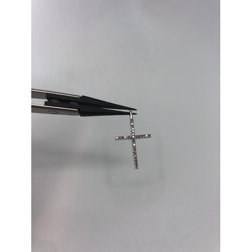 310 - 9k white gold cross with 0.15ct diamonds, 26mm long and weight 1.2g approx (ecn455)