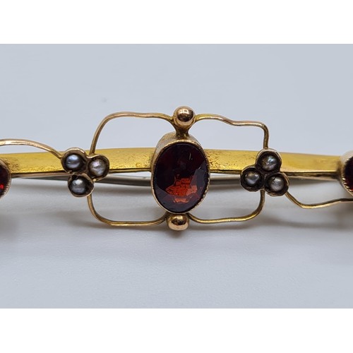 508 - Edwardian 9ct gold bar brooch with garnets and seed pearls, weight 1.8g & length 4.5cms