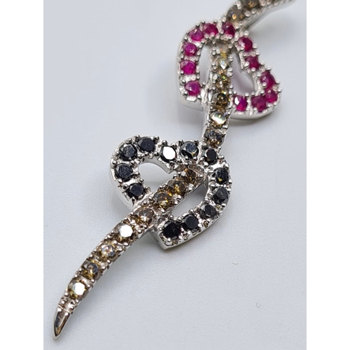 505 - 18ct white gold double heart pendant with diamonds and ruby's, weight 5.4g & length 5cms