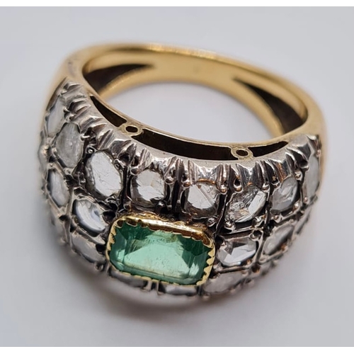 509 - Emerald and diamond ring in 18ct gold, weight 9.6g and Size S