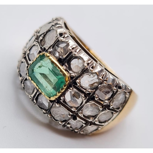 509 - Emerald and diamond ring in 18ct gold, weight 9.6g and Size S