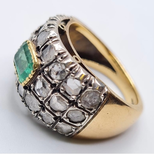 509 - Emerald and diamond ring in 18ct gold, weight 9.6g and Size S