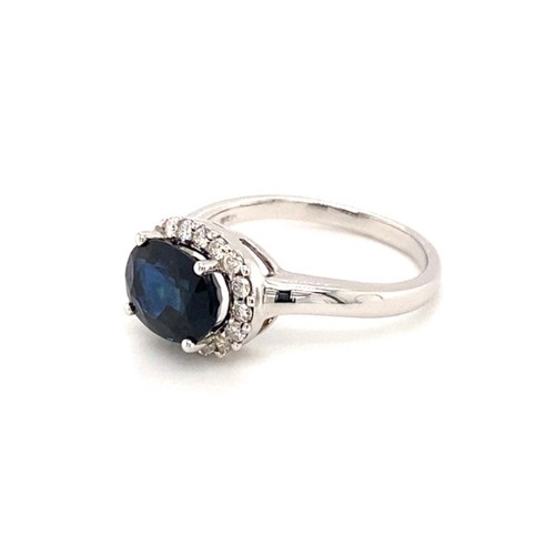 315 - 18K white gold ring with 2.29ct oval halo natural blue sapphire (Madagascar), and 0.29ct plain curve... 