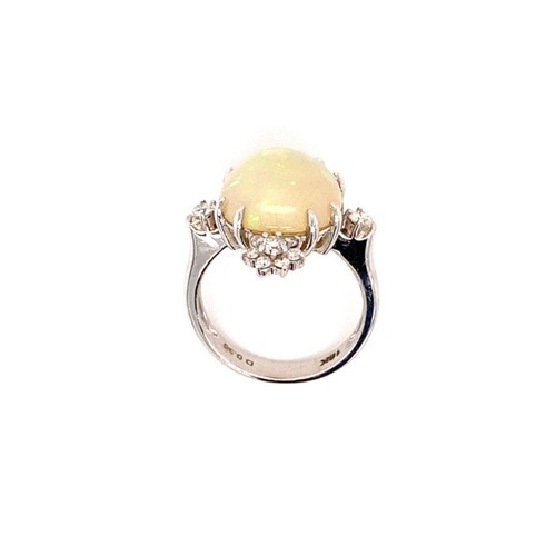 276 - 18K white gold ring with 6ct oval opal cabochon centre and 0.36ct diamonds (G/I, SI), weight 6.47g a... 