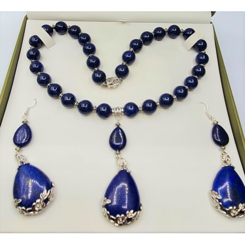 65 - A lapis lazuli and white metal (stamped 925) necklace and matching earrings set in a presentation bo... 