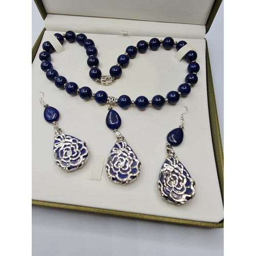 65 - A lapis lazuli and white metal (stamped 925) necklace and matching earrings set in a presentation bo... 