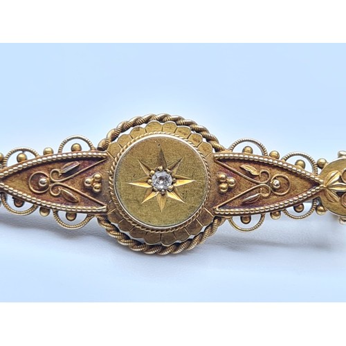 609 - Victorian 15ct gold bar brooch with diamond centre stone, weight 3.8g and 4cm long approx