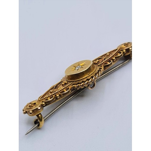 609 - Victorian 15ct gold bar brooch with diamond centre stone, weight 3.8g and 4cm long approx