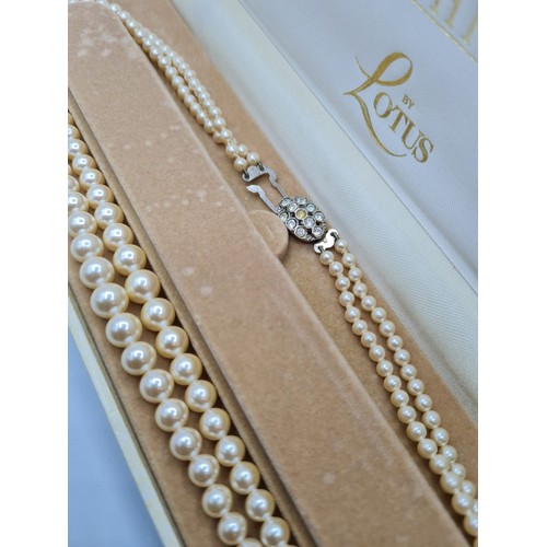 409 - A double string of graduated pearls in presentation box