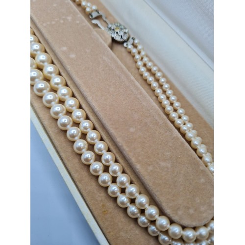 409 - A double string of graduated pearls in presentation box