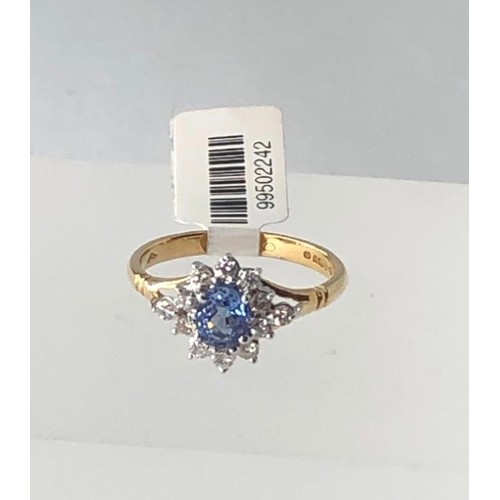 666 - 18k yellow gold cluster ring with 0.40ct diamonds and light blue oval sapphire centre, weight 3.3g a... 