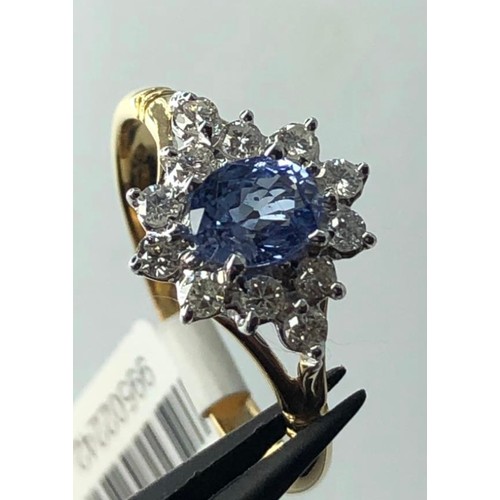 666 - 18k yellow gold cluster ring with 0.40ct diamonds and light blue oval sapphire centre, weight 3.3g a... 