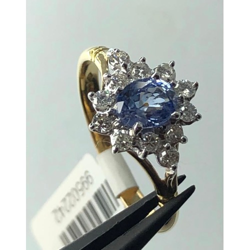 666 - 18k yellow gold cluster ring with 0.40ct diamonds and light blue oval sapphire centre, weight 3.3g a... 