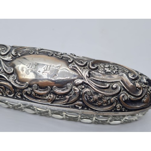 257 - Vintage Cut Glass and Silver Dressing Table Trinket Box. Having a long oval for with embossed flora ... 