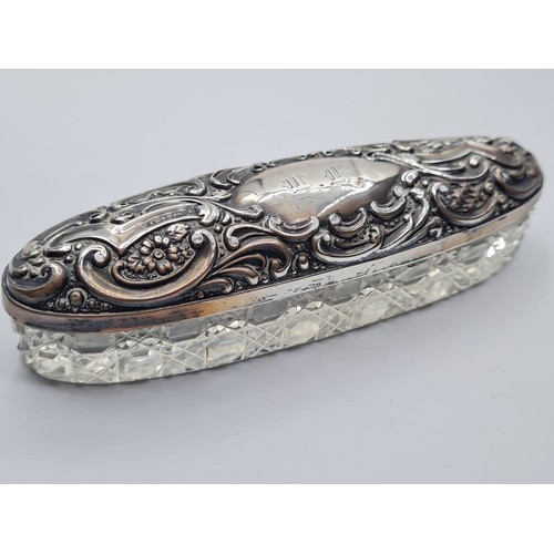 257 - Vintage Cut Glass and Silver Dressing Table Trinket Box. Having a long oval for with embossed flora ... 