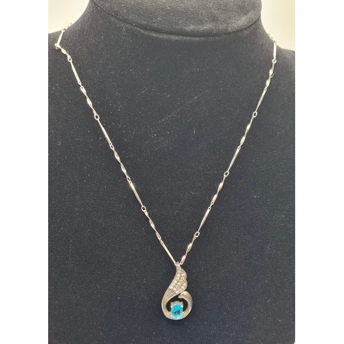 276 - Silver Pendant and Chain. Pendant having clear stones to top and blue topaz coloured oval solitaire ... 