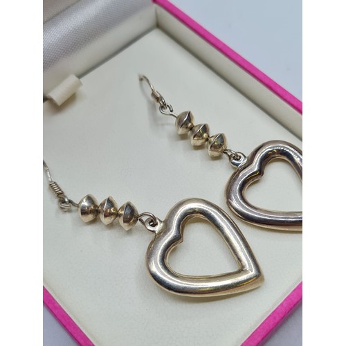 256 - Pair Silver Heart Earrings in drop form. Having three silver shapes above silver hearts, Quality Pai... 