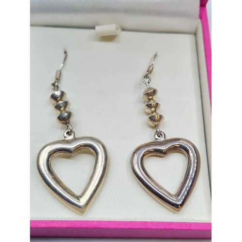 256 - Pair Silver Heart Earrings in drop form. Having three silver shapes above silver hearts, Quality Pai... 