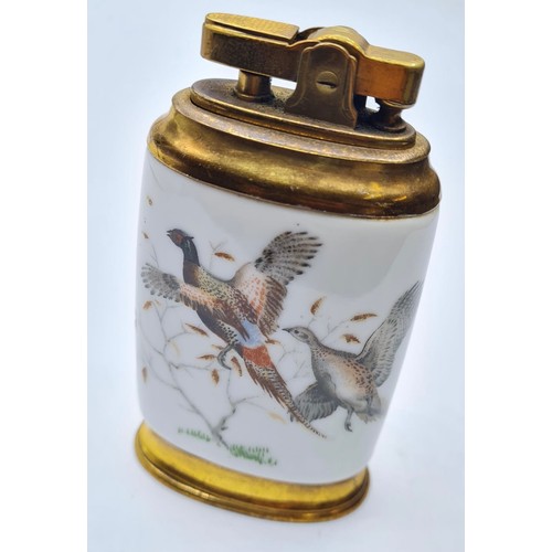 283 - Vintage Ceramic Table Lighter. Having birds to back and front. Flat oval shape, Gilded Metal.