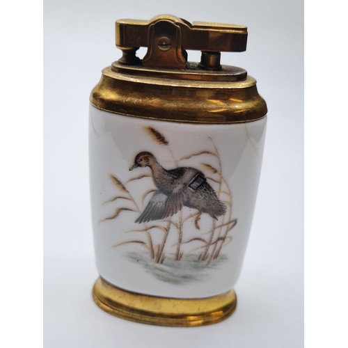 283 - Vintage Ceramic Table Lighter. Having birds to back and front. Flat oval shape, Gilded Metal.